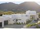 A modern white home with a large driveway and beautiful landscaping, offering great curb appeal at 6601 E San Miguel Ave, Paradise Valley, AZ 85253