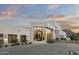 Inviting home exterior featuring a modern design, manicured landscaping, and a spacious paved driveway at 6601 E San Miguel Ave, Paradise Valley, AZ 85253
