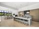 Spacious open-concept kitchen with an island featuring bar stools and seamlessly connected to the living area at 6601 E San Miguel Ave, Paradise Valley, AZ 85253