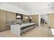 Contemporary kitchen featuring a large island with bar seating, modern lighting, and ample cabinet space at 6601 E San Miguel Ave, Paradise Valley, AZ 85253