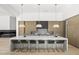 Modern kitchen with a large island, stylish pendant lighting, and sleek bar stools, perfect for gatherings at 6601 E San Miguel Ave, Paradise Valley, AZ 85253