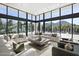 Bright living room with floor-to-ceiling windows and comfortable seating, offering stunning outdoor views at 6601 E San Miguel Ave, Paradise Valley, AZ 85253