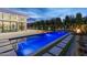 Stunning pool area with a sleek, modern design, complemented by a cozy outdoor fireplace and a spacious patio for entertaining at 6601 E San Miguel Ave, Paradise Valley, AZ 85253