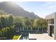 A luxurious pool area with mountain views and lush landscaping at 6601 E San Miguel Ave, Paradise Valley, AZ 85253