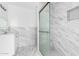 Modern bathroom featuring a glass-enclosed shower with marble-patterned walls at 6767 N 7Th St # 212, Phoenix, AZ 85014