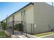 An exterior view of the apartment building with a secured gate and well-maintained landscaping at 6767 N 7Th St # 212, Phoenix, AZ 85014
