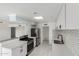 Updated kitchen boasts stainless steel appliances, modern countertops, and ample cabinet space and view to living room at 6767 N 7Th St # 212, Phoenix, AZ 85014