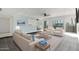 Bright living room featuring neutral decor, ceiling fans, and sliding glass doors to a balcony at 6767 N 7Th St # 212, Phoenix, AZ 85014