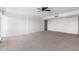 Spacious living room featuring neutral carpet, a ceiling fan, and large windows at 6767 N 7Th St # 212, Phoenix, AZ 85014