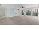 Bright and spacious living room featuring carpeted floors, and sliding glass doors to a balcony at 6767 N 7Th St # 212, Phoenix, AZ 85014