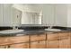 Bathroom featuring a double sink vanity and a large mirror at 6767 N 7Th St # 223, Phoenix, AZ 85014