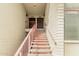 Exterior shot of an apartment building entrance with pink railings and door numbers 223 and 225 at 6767 N 7Th St # 223, Phoenix, AZ 85014