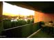 Balcony with outdoor furniture and a view of a peaceful street lined with lush trees and plants at 7021 E Earll Dr # 223, Scottsdale, AZ 85251