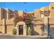 Charming condo exterior showcasing desert landscaping, private garages, and gated entry at 7021 E Earll Dr # 223, Scottsdale, AZ 85251