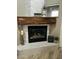 Elegant fireplace with wooden mantel and stylish décor at 7021 E Earll Dr # 223, Scottsdale, AZ 85251