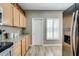 Bright kitchen featuring wooden cabinets, granite countertops, modern appliances, and natural light at 7021 E Earll Dr # 223, Scottsdale, AZ 85251