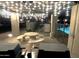 Outdoor seating area with picnic table and overhead string lights, perfect for evening entertainment at 7021 E Earll Dr # 223, Scottsdale, AZ 85251
