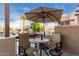Inviting patio seating with umbrella and lush landscaping in the background, perfect for outdoor enjoyment at 7021 E Earll Dr # 223, Scottsdale, AZ 85251
