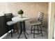 Cozy outdoor patio seating area featuring a table and two chairs, perfect for relaxing at 7021 E Earll Dr # 223, Scottsdale, AZ 85251