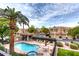 Community pool area with lounge chairs, a covered seating area, and neatly manicured landscaping at 7021 E Earll Dr # 223, Scottsdale, AZ 85251
