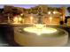 Elegant water fountain illuminated at night, enhancing the landscape of the neighborhood at 7021 E Earll Dr # 223, Scottsdale, AZ 85251