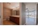 Bathroom featuring double sinks, a marble countertop, and an adjacent room with large bright window at 7157 E Rancho Vista Dr # 5003, Scottsdale, AZ 85251