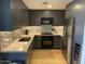 Modern kitchen with stainless steel appliances, gray cabinets, and a stylish backsplash at 7157 E Rancho Vista Dr # 5003, Scottsdale, AZ 85251