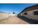 Large, dirt backyard with a brick home and block fence at 7928 N 46Th Ave, Glendale, AZ 85301