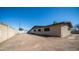 View of the side and back of the house with a large dirt backyard at 7928 N 46Th Ave, Glendale, AZ 85301