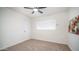 Clean bedroom featuring carpet, a ceiling fan, and a window with blinds at 7928 N 46Th Ave, Glendale, AZ 85301