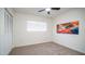Simple bedroom with carpet, a ceiling fan, and a window at 7928 N 46Th Ave, Glendale, AZ 85301