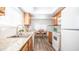 Functional kitchen featuring wooden cabinets and a view of the dining area at 7928 N 46Th Ave, Glendale, AZ 85301