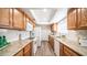Bright kitchen featuring stainless steel appliances, granite countertops, and wood cabinetry at 7928 N 46Th Ave, Glendale, AZ 85301