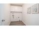Functional laundry room with white cabinets and wood-look flooring at 7928 N 46Th Ave, Glendale, AZ 85301