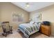 This cozy bedroom features a striped bedspread, rocking chair, and view to the outside at 804 N Jamaica Way, Gilbert, AZ 85234
