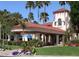 Grand clubhouse with a covered entrance, manicured lawn, and vibrant floral arrangements creates a welcoming atmosphere at 804 N Jamaica Way, Gilbert, AZ 85234