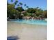 Large community pool with a waterfall feature and surrounded by mature trees and lush landscaping at 804 N Jamaica Way, Gilbert, AZ 85234