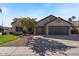 Charming single-Gathering home featuring a well-manicured lawn, mature landscaping, and a three-car garage at 804 N Jamaica Way, Gilbert, AZ 85234