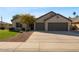 Charming single-story home with a well-manicured lawn, mature landscaping, and a two-car garage at 804 N Jamaica Way, Gilbert, AZ 85234