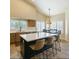 Bright, open kitchen featuring an island with seating and multiple windows with plantation shutters at 804 N Jamaica Way, Gilbert, AZ 85234