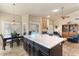 Modern open kitchen with a large center island, stainless steel appliances, and view into the living room at 804 N Jamaica Way, Gilbert, AZ 85234