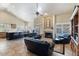 Open-concept living room with fireplace, comfortable leather seating and view of the pool at 804 N Jamaica Way, Gilbert, AZ 85234
