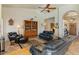 Spacious living room with a vaulted ceiling, comfortable leather seating, and a decorative bookshelf at 804 N Jamaica Way, Gilbert, AZ 85234