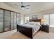 Relaxing main bedroom offers natural lighting, ceiling fan, and closet space at 804 N Jamaica Way, Gilbert, AZ 85234