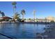 Community pool featuring diving boards, lounge chairs, a gazebo, and palm tree landscaping with beautiful lake views at 804 N Jamaica Way, Gilbert, AZ 85234