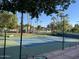 Community tennis courts surrounded by mature landscaping and trees, offering a recreational amenity at 804 N Jamaica Way, Gilbert, AZ 85234