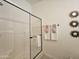 Shower in bathroom featuring a glass door and modern fixtures at 8700 E University Dr # 1024, Mesa, AZ 85207