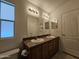 Bright bathroom featuring double sinks and updated lighting fixtures at 8700 E University Dr # 1024, Mesa, AZ 85207