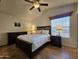 Cozy bedroom with a large bed, decorative lamps, and a ceiling fan for added comfort at 8700 E University Dr # 1024, Mesa, AZ 85207