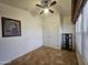 Neutral bedroom with a ceiling fan, tile floor, and natural light from the window with blinds at 8700 E University Dr # 1024, Mesa, AZ 85207